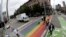 FILE - Pedestrians cross a street on a rainbow crosswalk in Seattle's Capitol Hill neighborhood, June 5, 2018. A New Jersey town has followed suit.