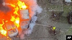 In this photo provided by the Ukrainian Emergency Service, emergency services personnel work to extinguish a fire following a Russian rocket attack in Poltava region Ukraine, Nov. 17, 2024. 