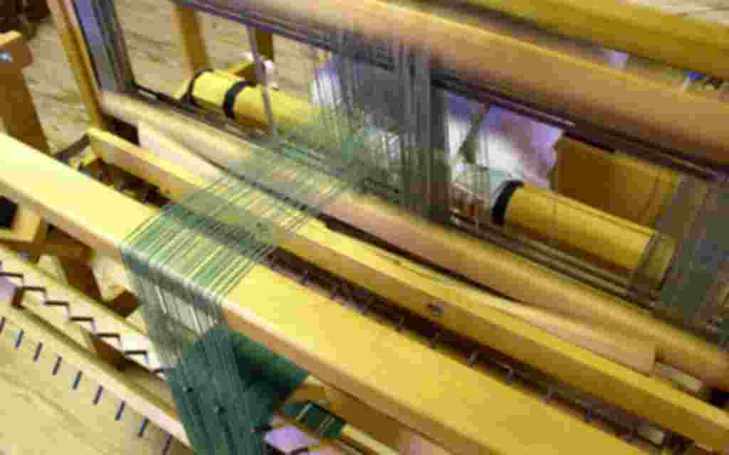 Crafts, a weaver at the loom