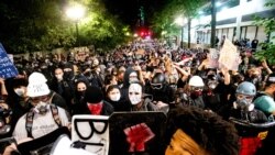 Black Lives Matter protesters march through Portland, Ore. after rallying at the Mark O. Hatfield United States Courthouse on Sunday, Aug. 2, 2020. Following an agreement between Democratic Gov. Kate Brown and the Trump administration to reduce…