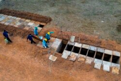 FILE - An aerial view of a burial at the Bom Jardim cemetery, the largest public cemetery in Fortaleza, Ceara state, Brazil, May 07, 2020.