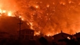 Flames rise as a wildfire burns next to the village of Ano Loutro, near Corinth, Greece, Sept. 29, 2024.