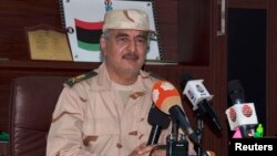 FILE - Ex-general Khalifa Haftar speaks during a news conference after surviving an assassination attempt in Al Marj, east of Benghazi, Libya, June 4, 2014. 