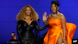 Beyonce, left, and Megan Thee Stallion accept the award for best rap song for 'Savage' at the 63rd annual Grammy Awards in Los Angeles, California, March 14, 2021. (AP Photo/Chris Pizzello)
