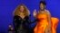 Beyonce, left, and Megan Thee Stallion accept the award for best rap song for 'Savage' at the 63rd annual Grammy Awards in Los Angeles, California, March 14, 2021. (AP Photo/Chris Pizzello)
