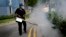 A pest control worker fumigates drains at a local housing development where Zika infections were reported in Singapore, Sept. 1, 2016.