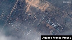 This satellite image released by Maxar Technologies on Dec. 23, 2021, reportedly shows Russian ground forces deployed at the Opuk training area on Dec. 22, 2021. (Photo by Handout/Satellite image ©2021 Maxar Technologies / AFP) 