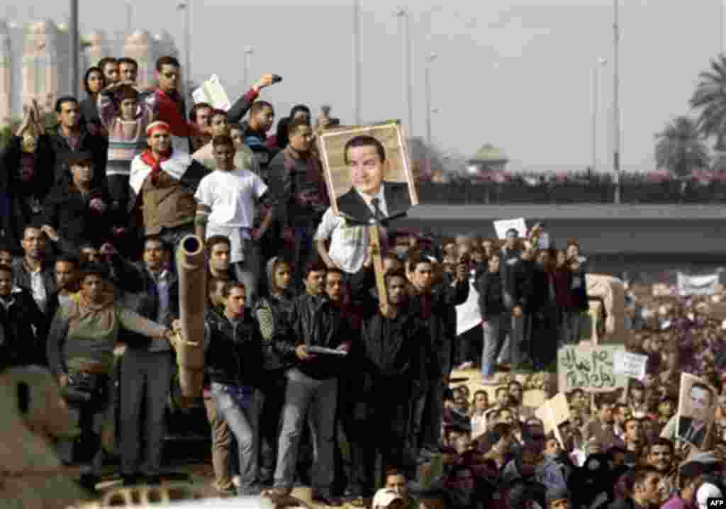 Pro-government demonstrators show their support for Egyptian President Hosni Mubarak, during a demonstration in Cairo, Egypt, Wednesday, Feb.2, 2011. Several thousand supporters of President Hosni Mubarak, including some riding horses and camels and wield