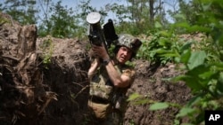 A Ukrainian serviceman carries a U.S. Stinger air defense missile launcher in a trench on the front line in Zaporizhzhia region, Ukraine, May 28, 2024.