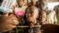FILE - Refugees from the Democratic Republic of Congo look on during the distribution of biscuits in Sebagoro, Uganda, on Feb. 15, 2018.