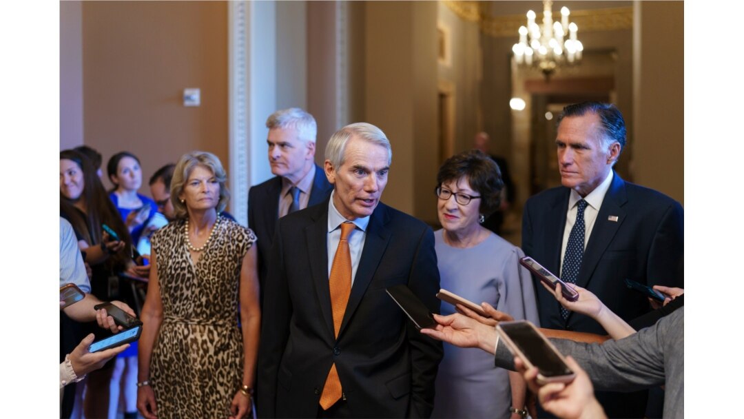 Republican Senators Rob Portman, center, joined by, from left, Lisa Murkowski, Bill Cassidy, Susan Collins, and Mitt Romney, announces an agreement with Democrats on a $1 trillion infrastructure bill, at the Capitol in Washington, July 28, 2021.