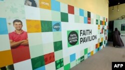 FILE -— A woman walks inside the "faith pavilion" at the venue of the COP28 in Dubai on December 6, 2023.