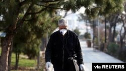 An Iranian man wears a protective mask against the coronavirus as he walks on a street in Tehran, Iran February 29, 2020.