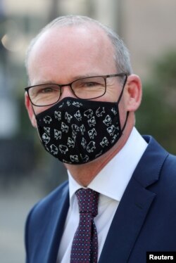 FILE - Irish Foreign Minister Simon Coveney, wearing a face mask, is seen after a European general affairs ministers council, in Brussels, Belgium, Sept. 22, 2020.