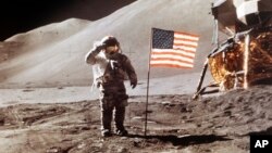 FILE - In this July 30, 1971 NASA photo, Apollo 15 Lunar Module Pilot James B. Irwin salutes while standing beside the fourth American flag planted on the moon. On March 26, 2019, Vice President Mike Pence called for landing astronauts on the moon within five years.