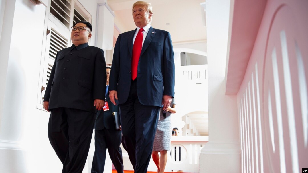 North Korea leader Kim Jong Un and U.S. President Donald Trump walk along the balconies at the Capella resort on Sentosa Island, June 12, 2018 in Singapore.