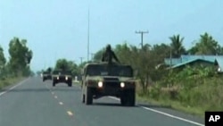 Thai military trucks with soldiers are driven to the Thai-Cambodia border for reinforcement in this still image taken from video April 22, 2011. Thai and Cambodian soldiers fought with rocket-propelled grenades and guns on their disputed border on Friday 