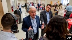 Jeff Sessions talks with reporters as he campaigns at a Jefferson County GOP candidate pancake breakfast, Feb. 29, 2020, in Birmingham, Ala.