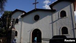 A woman walks into a church at the 23 de Enero neighborhood in Caracas, Venezuela, Jan. 30, 2017. Clergy meddling in politics has recently reawakened a long-simmering church-state antagonism in the South American nation.