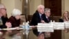 FILE - Federal Reserve Board member Daniel Tarullo, center, accompanied by Chair Janet Yellen (2nd left) Vice Chair Stanley Fischer (left), Jerome Powell, (2nd right) and Lael Brainard (right) during an open board meeting in Washington, Dec. 15, 2016.