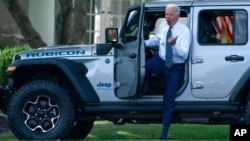 President Joe Biden gets out of a Jeep Wrangler Rubicon 4xE on the South Lawn of the White House in Washington, Aug. 5, 2021.