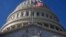 FILE - The flag waves in front of the U.S. Capitol Building in Washington, Nov., 19, 2011.
