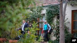 FILE - Police execute a search warrant on the home of an Australian intelligence officer in Canberra, Sept. 4, 2019. News Corp. Australia executive Campbell Reid linked the raid to a June 4 raid on journalist Annika Smethurst’s home.