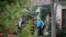 FILE - Police execute a search warrant on the home of an Australian intelligence officer in Canberra, Sept. 4, 2019. News Corp. Australia executive Campbell Reid linked the raid to a June 4 raid on journalist Annika Smethurst’s home.