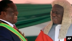 FILE: Zimbabwean President Emmerson Mnangagwa,left, is congratulated by Chief Justice Luke Malaba after taking his oath during his inauguration ceremony at the National Sports Stadium in Harare, Sunday, Aug. 26, 2018. T