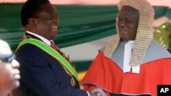 FILE: Zimbabwean President Emmerson Mnangagwa,left, is congratulated by Chief Justice Luke Malaba after taking his oath during his inauguration ceremony at the National Sports Stadium in Harare, Sunday, Aug. 26, 2018. (AP Photo/Tsvangirayi Mukwazhi)