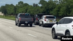 Police vehicles stop a car, following reports of shots fired near the golf course of Republican presidential candidate and former President Donald Trump, near Palm City, Florida, Sept. 15, 2024. (Martin County Sheriff's Office/Handout via Reuters)