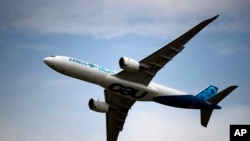 An Airbus A350 performs a demonstration flight at Paris Air Show, in Le Bourget, north east of Paris, France, Tuesday, June 18, 2019. The world's aviation elite are gathering at the Paris Air Show with safety concerns on many minds after two crashes…