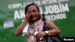 A relative of a prisoner reacts in front of the main entrance of Anisio Jobim prison in Manaus, Brazil, Jan. 3, 2017. 