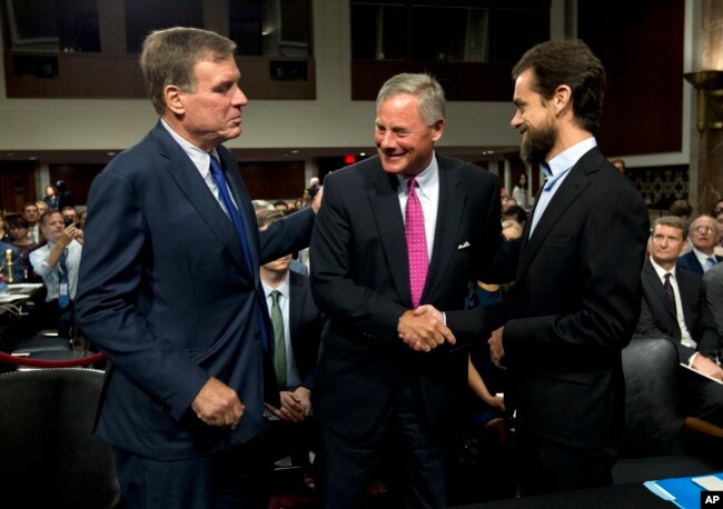 Senate Intelligence Committee Vice Chairman Mark Warner, D-Va., left, and Chairman Richard Burr, R-N.C., center, greet Twitter Chief Executive Officer Jack Dorsey before he testifies before their committee on Capitol Hill, Sept. 5, 2018, in Washington.