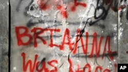 FILE - Graffiti is show on the damaged base of a Confederate memorial that was removed overnight in Birmingham, Ala., June 2, 2020. 