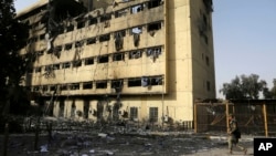 FILE - An Iraqi soldier patrols by a hospital in Mosul, Iraq, Jan. 10, 2017. Airstrikes on Saturday took out offices which Islamic State militants operated on the grounds of another hospital in the city.