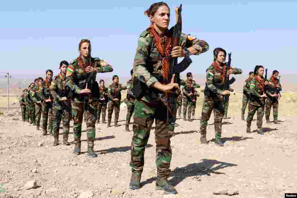 A group of Iranian Kurdish women who have joined Kurdish peshmerga fighters take part in a training session in a military camp in Erbil, Iraq.