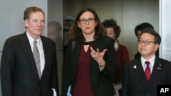 European Commissioner for Trade Cecilia Malmstrom, Japanese Minister for Economy, Trade and Industry Hiroshige Seko, right, and U.S. Trade Representative Robert Lighthizer are pictured prior to a meeting at EU headquarters in Brussels, March 10, 2018.
