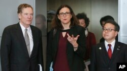 European Commissioner for Trade Cecilia Malmstrom, Japanese Minister for Economy, Trade and Industry Hiroshige Seko, right, and U.S. Trade Representative Robert Lighthizer are pictured prior to a meeting at EU headquarters in Brussels, March 10, 2018.