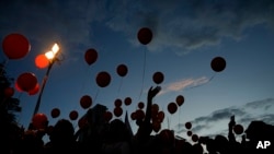 Protesters release balloons as they call for the release of the Bibas family, whose members are being held hostage in the Gaza Strip by the Hamas militant group, in Tel Aviv, Nov. 28, 2023.