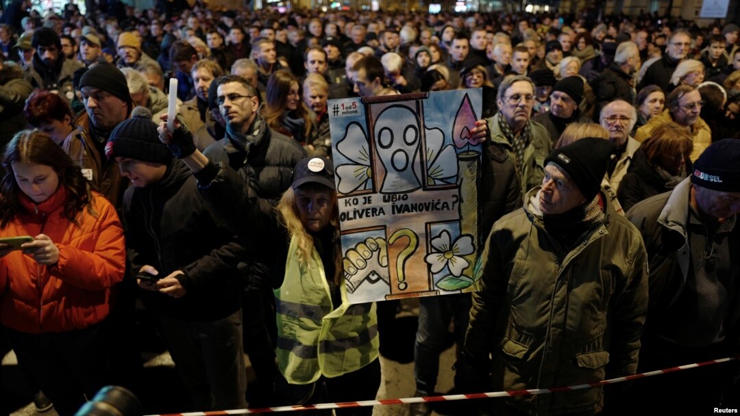 People attend a march on the first anniversary of the murder of opposition Serb politician Oliver Ivanovic, in Belgrade, Serbia Jan. 16, 2019.