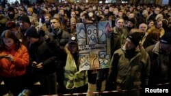 People attend a march on the first anniversary of the murder of opposition Serb politician Oliver Ivanovic, in Belgrade, Serbia Jan. 16, 2019.
