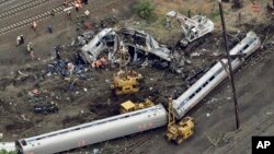 FILE- Emergency personnel work at the scene of a derailment in Philadelphia of an Amtrak train headed to New York, May 13, 2015. 