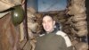 Alan Coleman poses inside a room designed to resemble a trench from World War I. (D. Taylor/VOA)