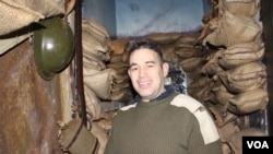 Alan Coleman poses inside a room designed to resemble a trench from World War I. (D. Taylor/VOA)