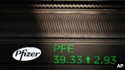 A stock ticker with Pfizer stock information is shown at the New York Stock Exchange, Nov. 9, 2020.