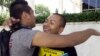 Students Irvis Orozco, left, and Jorge Gutierrez hug outside the US Citizenship and Immigration Services at the Federal Building in Los Angeles Wednesday, Aug. 15, 2012.