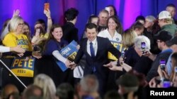 FILE - Democratic presidential candidate Pete Buttigieg greets attendees during a campaign event at a high school in Indianola, Iowa, Dec. 22, 2019.
