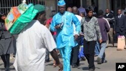 People walk down a street in the capital city of Zimbabwe, Harare, July, 12, 2012.