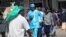 People walk down a street in the capital city of Zimbabwe, Harare, July, 12, 2012.